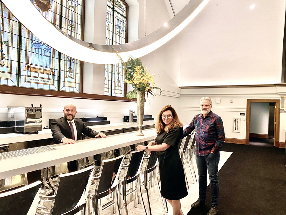 Three people touring The Mark, one of the winning projects in 2019.